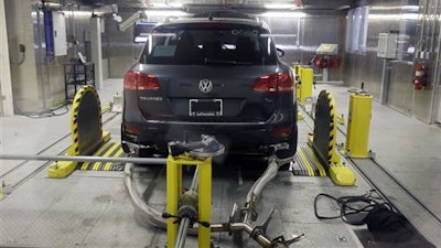 In this Oct. 13, 2015, file photo, a Volkswagen Touareg diesel is tested in the Environmental Protection Agency's cold temperature test facility in Ann Arbor, Mich. Volkswagen will spend more than $15 billion to settle consumer lawsuits and government allegations that it cheated on emissions tests in what lawyers are calling the largest auto-related class-action settlement in U.S. history. The settlement was revealed Tuesday, June 28, 2016, by a U.S. District Court in San Francisco.