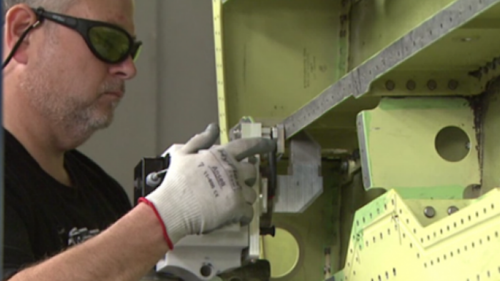Lockheed Martin employee Spencer Beavers uses the first laser ablation system implemented into the F-35 wing structure production at Lockheed Martin’s factory in Fort Worth, Texas.