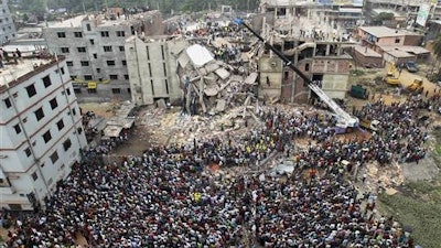 In this April 25, 2013, file photo, Bangladeshi people gather as rescuers look for survivors and victims at the site of a building that collapsed a day earlier, in Savar, near Dhaka, Bangladesh. A Bangladesh court on Monday, July 18, 2016, indicted 41 people for murder in the 2013 deaths of more than 1,100 people in the collapse of a building that housed five garment factories outside the capital.