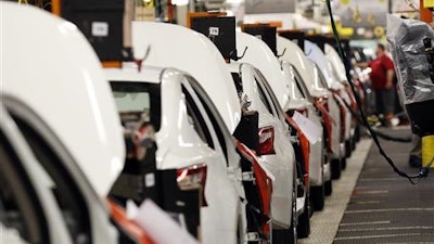 In this April 6, 2016, photo, an assembly line of new 2016 Altimas await backseat installations at the Nissan Canton Vehicle Assembly Plant in Canton, Miss. On Friday, July 15, 2016, the Federal Reserve reports on U.S. industrial production for June.