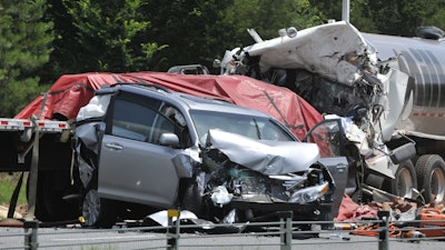 This AP File file photo shows a minivan and two semitrailers in an early morning fatal wreck on I-85 South near Shorter, Alabama. According to the CDC, traffic deaths are down most everywhere, but fatalities on the road are still a bigger problem in the United States than in other affluent countries.