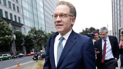 In this April 21, 2016 file photo, Robert Giuffra, an attorney for Volkswagen, leaves the Phillip Burton Federal Building after a court hearing, in San Francisco. A $15 billion settlement over Volkswagen's diesel emissions cheating scandal faces a critical test, as a federal judge in San Francisco decides whether to grant it preliminary approval on Tuesday, July 26.