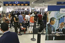 In this Thursday, May 26, 2016, photo, travelers stand in line as they prepare to pass through a Transportation Security Administration checkpoint at Miami International Airport, in Miami. The Transportation Security Administration said Tuesday, July 5, 2016, it will work with American Airlines to speed up security lines. The agency will test CT scanners in Phoenix, and roll out redesigned security lanes this fall in Chicago, Dallas, Los Angeles and Miami.