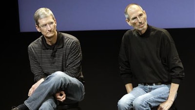 This July 16, 2010, file photo shows Apple's Tim Cook, left, and Steve Jobs, right, during a meeting at Apple in Cupertino, Calif. Apple wants to encourage millions of iPhone owners to register as organ donors through a software update that will add an easy sign-up button to the health information app that comes installed on every smartphone the company makes. CEO Cook says he hopes the new software, set for limited release in early July 2016, will help ease a critical and longstanding donor shortage. He said the problem hit home when his friend and former boss, Apple co-founder Jobs, endured an “excruciating” wait for a liver transplant in 2009.