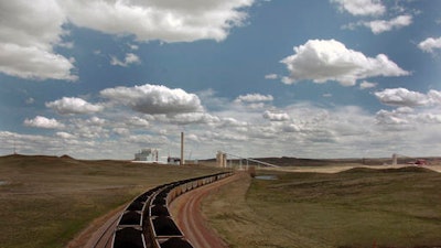 In this Thursday, April 29, 2010 file photo, a pair of coal trains idle on the tracks near Dry Fork Station, a coal-fired power plant being built by the Basin Electric Power Cooperative near Gillette, Wyo. Teams from Canada, China, Finland, India, Scotland, Switzerland and the U.S. have submitted 47 proposals for the first round of a $20 million contest to put power-plant emissions to profitable use, NRG COSIA Carbon XPRIZE officials announced Wednesday, July 27, 2016.