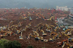 In this Tuesday, Dec. 22, 2015 file photo, rescuers search for potential survivors following a landslide at an industrial park in Shenzhen in south China's Guangdong province. China's Cabinet said Friday, July 15, 2016 that 53 people are in custody in an investigation into the landslide that killed 73 people and left four others missing last year.