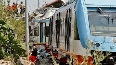 A view of the scene of a train accident after two commuter trains collided head-on near the town of Andria, in the southern region of Puglia, killing several people, Tuesday, July 12, 2016.