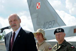 Polish Defense Minister Antoni Macierewicz speaks in front of a Polish Air Force F-16 fighter jet during a farewell ceremony of Polish soldiers leaving for Kuwait to take part in the operation Inherent Resolve , in Janow, Poland, Monday, July 4, 2016. During an interview Monday Macierewicz told The Associated Press that decisions to be approved at this week's NATO summit in Warsaw will build a force aimed at deterring any aggressive intentions by Russia against the West.