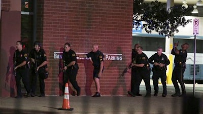 Dallas police respond after shots were fired during a protest over recent fatal shootings by police in Louisiana and Minnesota, Thursday, July 7, 2016, in Dallas. Snipers opened fire on police officers during protests; several officers were killed, police said.