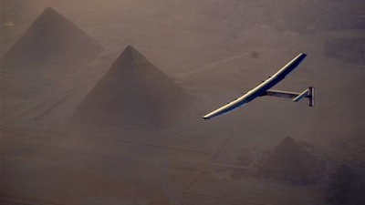 In this Wednesday, July 13, 2016, handout image provided by Solar Impulse, the Solar Impulse 2 flying over the pyramids, Egypt Cairo. The experimental solar-powered airplane has arrived in Egypt as part of its global voyage.