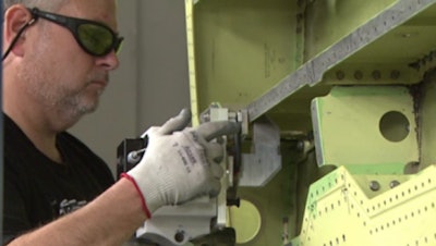 Lockheed Martin employee Spencer Beavers uses the first laser ablation system implemented into the F-35 wing structure production at Lockheed Martin’s factory in Fort Worth, Texas.