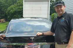 In this 2015 file photo provided by his neighbor, Krista Kitchen, Joshua Brown stands by his new Tesla electric car near his home in Canton, Ohio. Brown died in an accident in Florida on May 7, 2016 in the first fatality from a car using self-driving technology. According to statements by the government and the automaker, his vehicle's cameras didn't make a distinction between the white side of a turning tractor-trailer and the brightly lit sky while failing to automatically activate its brakes.