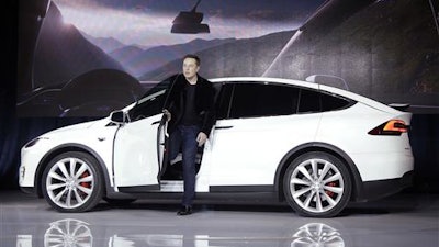 In this Sept. 29, 2015 file photo, Elon Musk, CEO of Tesla Motors Inc., introduces the Model X car at the company's headquarters in Fremont, Calif. A Tesla in Autopilot mode can drive itself but it's not a 'self-driving' vehicle, at least as far as safety regulators are concerned. So, instead of coming under heavy government scrutiny before being sold to the public, Tesla can mass-produce cars that automatically adjust speed with the flow of traffic, keep their lane and slam the brakes in an emergency.