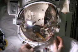 Astronaut Luca Parmitano fills a helmet with water to demonstrate his near-drowning emergency during a spacewalk.