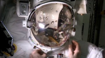Astronaut Luca Parmitano fills a helmet with water to demonstrate his near-drowning emergency during a spacewalk.