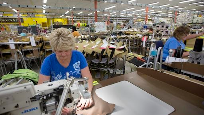Misty Thurston stitches suits for firefighters at Globe Manufacturing Co. Monday July 25, 2016, in Pittsfield, N.H. New Hampshire has a 2.7 percent unemployment rate, but the state's manufacturing industry is struggling to find enough skilled workers to fill open jobs. Northern New England's rapidly aging population means the problem will only get worse as skilled workers retire and not enough young people are available to replace them.