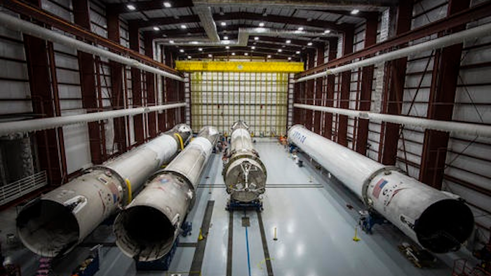 This June 6, 2016 photo made available by SpaceX shows recovered Falcon rocket boosters in a hangar at the Kennedy Space Center on Merritt Island, Fla. The company says it can save considerable time and money by reusing the big, expensive parts.