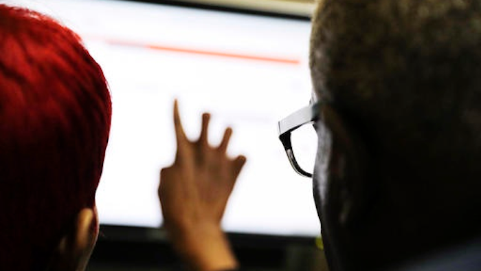 In this Thursday, March 3, 2016, file photo, Georgia Department of Labor services specialist Louis Holliday, right, helps a woman with a job search on a computer at an unemployment office in Atlanta. On Thursday, Aug. 11, the Labor Department reports on the number of people who applied for unemployment benefits in the previous week.