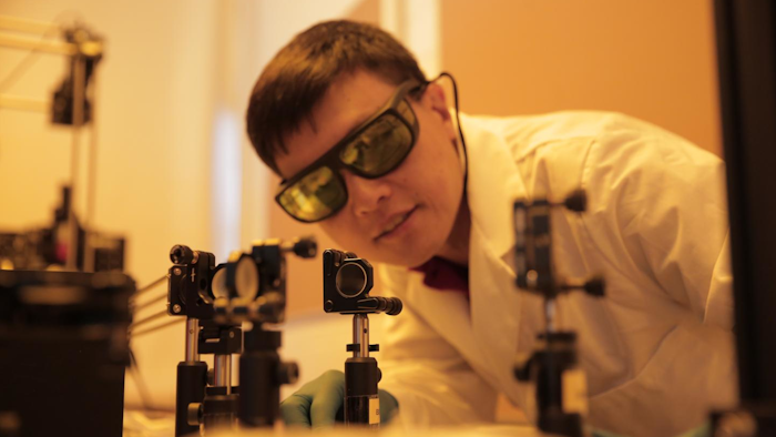 Hongrui Jiang inspects the alignment of a light source to illuminate new-generation lateral solar cells. The solar cells developed by Jiang's group harvest almost three times more electricity from incoming light as compared to existing technologies.