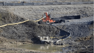 In this Jan. 14, 2016 file photo, a drainage pipe that was the original culprit of the coal ash spill is seen at the Dan River Steam Station in Eden, N.C. North Carolina's top public health official acted unethically and possibly illegally by telling residents living near Duke Energy coal ash pits that their well water is safe to drink when it's contaminated with a chemical known to cause cancer, a state toxicologist said in sworn testimony.