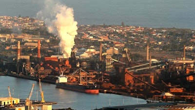 In this July 2, 2014 file photo, smoke billows out of a chimney stack of BHP steelwork factories at Port Kembla, south of Sydney, Australia. The world's biggest miner, BHP Billiton, on Tuesday, Aug. 16, 2016, reported a $6.4 billion loss, the worst full-year result in the Anglo-Australian company's history. BHP said the result for the fiscal year ending June 30 came from a 31 percent fall in revenue to $30.1 billion amid weak commodity prices, write downs of U.S. oil and gas assets and a disaster at a Brazilian mining joint venture.