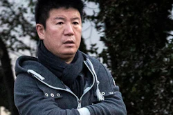 In this Aug. 17, 2016 photo, William Yan leaves his apartment in Auckland, New Zealand. Former pharmaceutical executive, Yan, who's accused by Chinese authorities of embezzling money and fleeing to New Zealand has settled his case for more than $30 million.