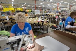 Misty Thurston stitches suits for firefighters at Globe Manufacturing Co. Monday July 25, 2016, in Pittsfield, N.H. New Hampshire has a 2.7 percent unemployment rate, but the state's manufacturing industry is struggling to find enough skilled workers to fill open jobs. Northern New England's rapidly aging population means the problem will only get worse as skilled workers retire and not enough young people are available to replace them.