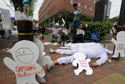 In this May 1, 2016 photo, members of the electronics industry workers advocacy group Banolim perform during a rally against the electronics giant's response to former employees' health concerns on a street in Seoul, South Korea.