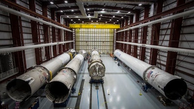 This June 6, 2016 photo made available by SpaceX shows recovered Falcon rocket boosters in a hangar at the Kennedy Space Center on Merritt Island, Fla. The company says it can save considerable time and money by reusing the big, expensive parts.