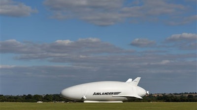 The Airlander 10, part plane, part airship, goes through pre-flight checks at Cardington airfield in Bedfordshire, England, Sunday Aug. 14, 2016. The makers of a blimp-shaped, helium-filled airship billed as the world's biggest aircraft postponed its maiden flight at the last minute on Sunday.
