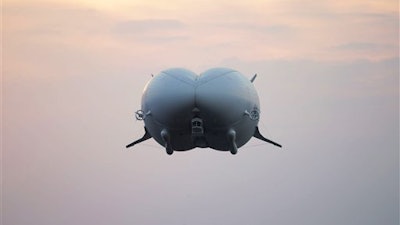 The Airlander 10 after taking flight, from Cardington airfield in Bedfordshire, England, Wednesday Aug. 17, 2016. A blimp-shaped airship billed as the world's largest aircraft has taken off for the first time, days after an earlier attempt was scuttled by a last-minute technical hitch. The 302-foot (92-meter) Airlander 10 — nicknamed the 'flying bum' because of its bulbous front end — rose slowly into the air Wednesday from an airfield 45 miles (73 kilometers) north of London.