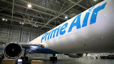 Amazon.com boxes are shown stacked near a Boeing 767, an Amazon 'Prime Air' cargo plane on display Thursday, Aug. 4, 2016, in a Boeing hangar in Seattle. Amazon unveiled its first branded cargo plane Thursday, one of 40 jetliners that will make up Amazon's own air transportation network of 40 Boeing jets leased from Atlas Air Worldwide Holdings and Air Transport Services Group Inc., which will operate the air cargo network.