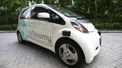 An autonomous vehicle is parked for its test drive in Singapore Wednesday, Aug. 24, 2016. The world’s first self-driving taxis, operated by nuTonomy, an autonomous vehicle software startup, will be picking up passengers in Singapore starting Thursday, Aug. 25. The service will start small - six cars now, growing to a dozen by the end of the year. The ultimate goal, say nuTonomy officials, is to have a fully self-driving taxi fleet in Singapore by 2018, which will help sharply cut the number of cars on Singapore’s congested roads.