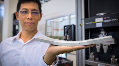 This is NTU Asst Prof Yang En-Hua, holding the bendable concrete which his team had invented.