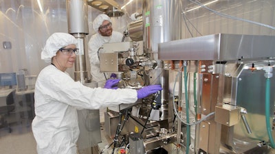 Brookhaven National Laboratory Center for Functional Nanomaterials researchers Gwen Wright and Aaron Stein are at the electron beam lithography writer in the CFN cleanroom.