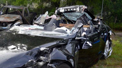 This file photo provided by the National Transportation Safety Board via the Florida Highway Patrol shows the Tesla Model S that was being driven by Joshua Brown, who was killed when the Tesla sedan crashed while in self-driving mode on May 7, 2016. A person familiar with the discussions says Tesla has told Senate committee staffers that its engineers have two main theories about what caused the fatal crash. Both involve the car's cameras and radar. Tesla officials disclosed the theories a briefing with U.S. Senate Commerce Committee staff members Thursday, July 28, 2016, said the person, who didn't want to be identified because the meeting was private.