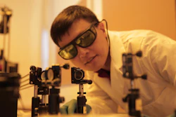 Hongrui Jiang inspects the alignment of a light source to illuminate new-generation lateral solar cells. The solar cells developed by Jiang's group harvest almost three times more electricity from incoming light as compared to existing technologies.