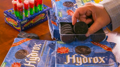 In this Wednesday, Aug. 2, 2016 photo, Ellia Kassoff, CEO of Leaf Brands, a Newport Beach candy and cookie company, poses with Hydrox cookies at the offices of his distributor in Pico Rivera, Calif. Kassoff is concerned about how the public will react to labels that say its food has GMOs _ although the bulk of the nation’s corn and soybean crops are now genetically modified.