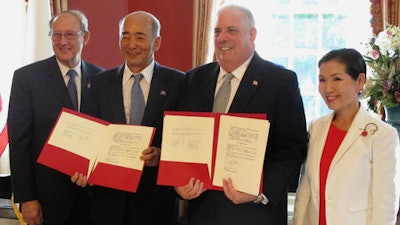 Gov. Larry Hogan, second from right, and Japanese Ambassador to the United States Kenichiro Sasae, second from left, pose for a photo as they sign a Memorandum of Cooperation between Maryland and Japan at the Maryland governor's residence in Annapolis, Md., Wednesday, Aug. 24, 2016. The ambassador said Japan has authorized $2 million to help study building a high-speed magnetic-levitation train between Washington and Baltimore. Maryland first lady Yumi Hogan is standing far right. Maryland Secretary of State John Wobensmith is standing far left.