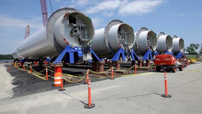 In this July 25, 2016 photo, sections of wind turbine towers sit in rows at a staging site at Port of Providence, in Providence, R.I. Deepwater Wind anticipates opening the first U.S. offshore wind farm off Rhode Island's coast in the fall.