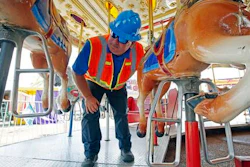 In this Tuesday, Oct. 6, 2015 file photo, amusement device inspector Avery Wheelock inspects the safety pins on a children's merry-go-round at the Mississippi State Fair in Jackson, Miss. In some parts of the U.S., the thrill rides that hurl kids upside down, whirl them around or send them shooting down slides are checked out by state inspectors before customers climb on. But in other places, they are not required to get the once-over.