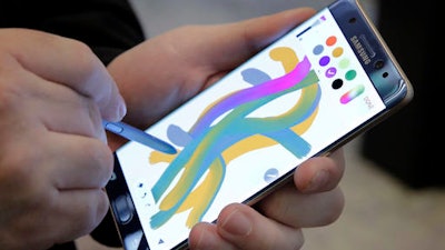In this July 28, 2016, photo, a color blending feature of the Galaxy Note 7 is demonstrated in New York. Samsung releases an update to its jumbo smartphone and virtual-reality headset, mostly with enhancements rather than anything revolutionary during a preview of Samsung products.