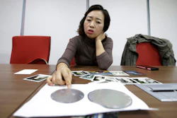 In this March 5, 2016 photo, Park Min-sook, 43, a former Samsung chip worker and a breast cancer survivor, explains how silicon wafers are used in the semiconductor process during an interview in Seoul, South Korea. An Associated Press investigation has found South Korean authorities have, at Samsung’s request, repeatedly withheld crucial information about the chemicals that workers were exposed to at its computer chip and liquid crystal display factories. Workers who have fallen ill due to the chemicals have the right to access such data so they can apply for workers’ compensation from the state. Without this information, government officials commonly reject their cases.