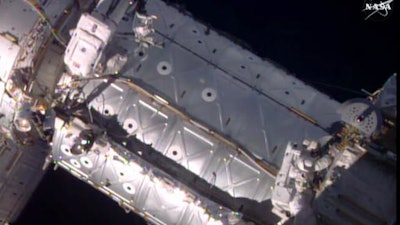 This image provided by NASA shows American astronauts Jeffrey Williams, left, and Kate Rubins taking a spacewalk to hook up a docking port outside the International Space Station on Friday, Aug. 19, 2016. The docking port will be used by future commercial crew capsules. SpaceX delivered this new gateway last month.