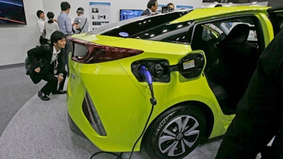 In this Wednesday, June 15, 2016, file photo, Toyota Motor Corp's Prius PHV is displayed at the Smart Community Japan exhibition in Tokyo, Japan. Toyota's much ballyhooed plug-in hybrid Prius Prime is being pushed back by several months, with the new sales date set for late this year or early next year. Toyota Motor Corp. said Wednesday the launch dates were being delayed for Japan, but not for the U.S. and Europe because they were set to follow Japan from the start. It was unclear what the dates were for any of the regions.