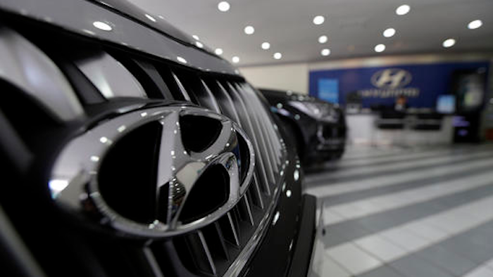 In this April 26, 2016 file photo, the logo of Hyundai Motor Co. is seen on a vehicle displayed at the company's showroom in Seoul, South Korea. Hyundai is recalling about 41,000 small SUVs in the U.S., Thursday, Sept. 15, because a software glitch can stop the vehicles from accelerating. The recall came after pressure from the National Highway Traffic Safety Administration. It covers 2016 Tucson models with seven-speed dual-clutch automatic transmissions made from May 20, 2015 to May 31, 2016.