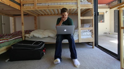Phillip Cohen in the bedroom of a hacker hostel in Menlo Park, CA.