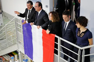 Michel Catalano (L), the owner of the print works, French President Francois Hollande (2ndL) and the Catalano family attend the inauguration of the rebuilt groupe Michel Catalano printing house where brothers Kouachi, Charlie Hebdo's attackers, were trapped and killed, in Dammartin-en-Goele, France.