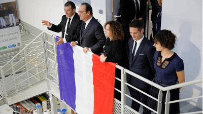Michel Catalano (L), the owner of the print works, French President Francois Hollande (2ndL) and the Catalano family attend the inauguration of the rebuilt groupe Michel Catalano printing house where brothers Kouachi, Charlie Hebdo's attackers, were trapped and killed, in Dammartin-en-Goele, France.
