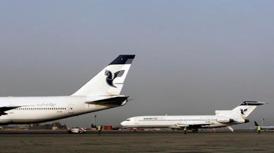 In this March 2, 2008 file photo, two passenger planes of Iran's national air carrier, Iran Air, are parked at the Mehrabad Airport in Tehran, Iran. Airbus announced Wednesday, Sept. 21, 2016, that the U.S. government has granted it a license allowing it to sell the first 17 planes involved in a landmark deal with Iran. Most Iranian planes were purchased before the 1979 Islamic Revolution that ousted Shah Mohammad Reza Pahlavi and brought Islamists to power.